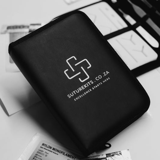 Black travel case with 'Suturekits.co.za' logo on a white surface with medical supplies.