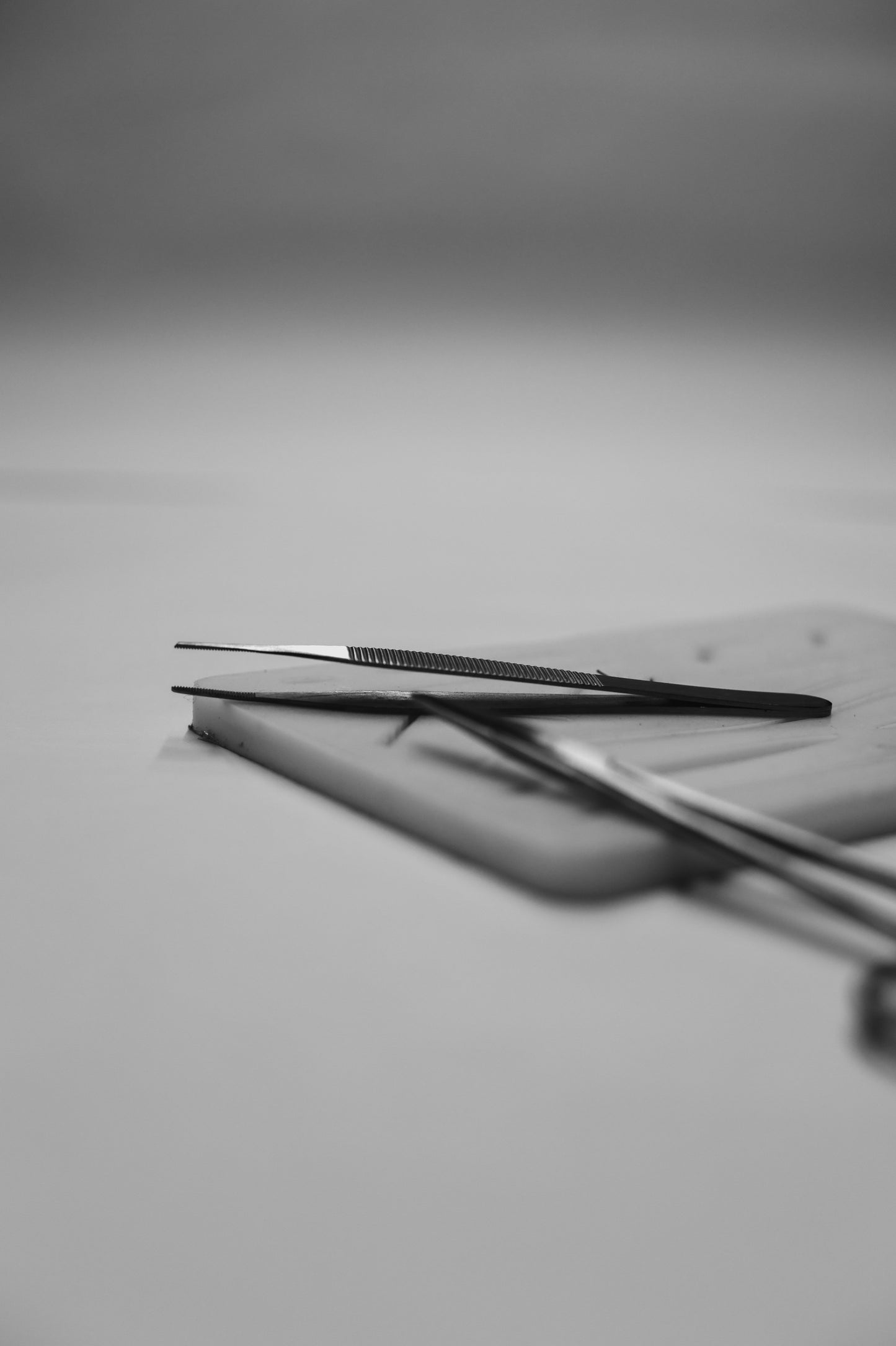 Pair of scissors on a gray surface